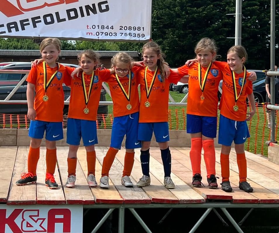 Marlow United girls team on the podium with their medals