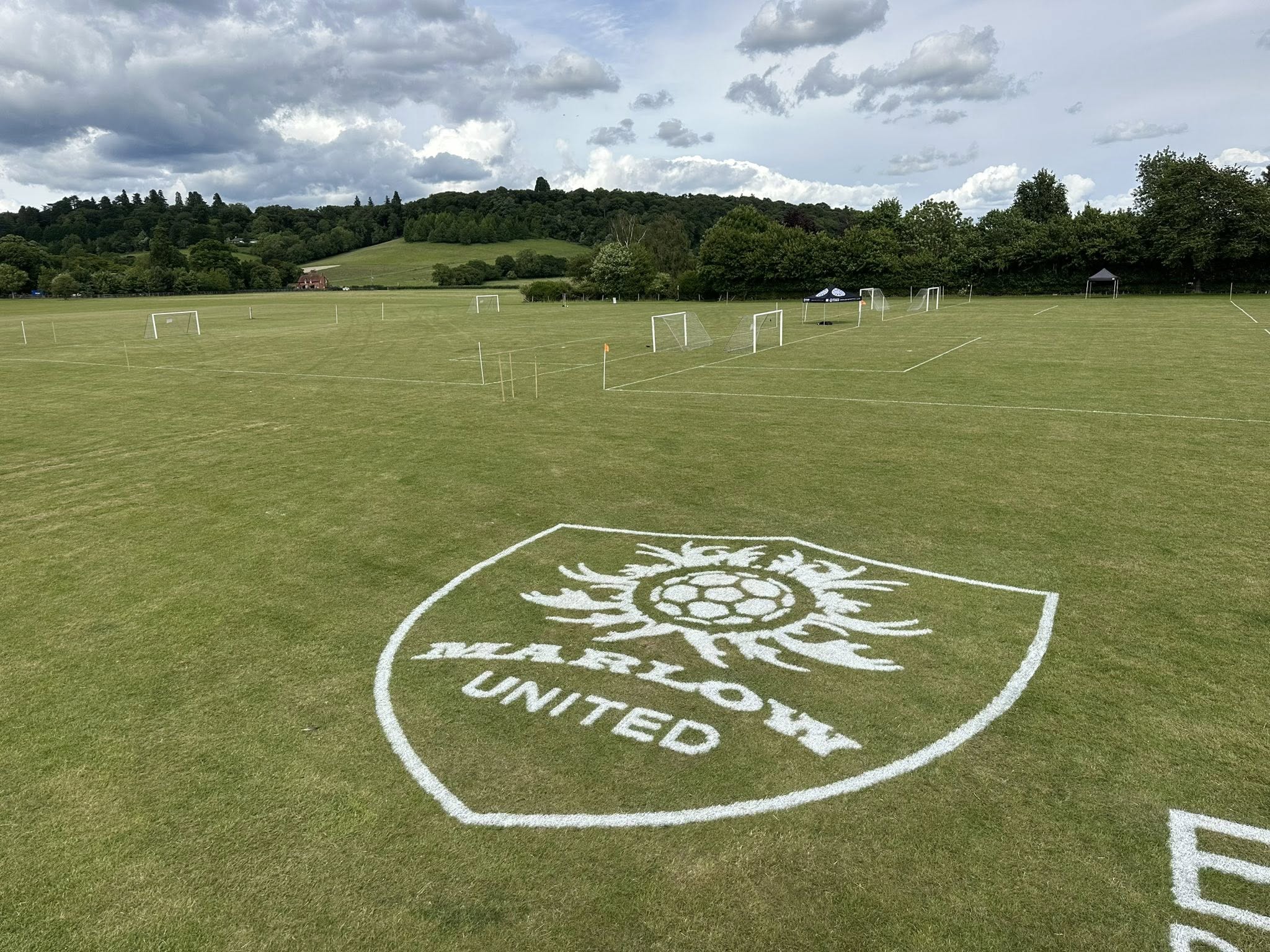 The Marlow United crest painted onto the showground grass