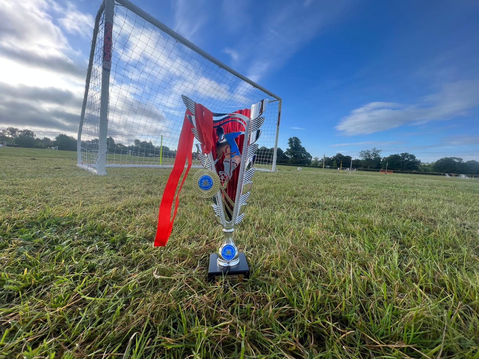 Tournament trophy in front of a goal